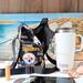 The Pittsburgh Steelers team logo is displayed in the print of a water bottle bag. Beside the bag is a Yeti 20 ounce Tumbler. 